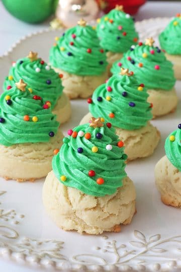 A side view of Christmas tree drop cookies on an embellished platter.